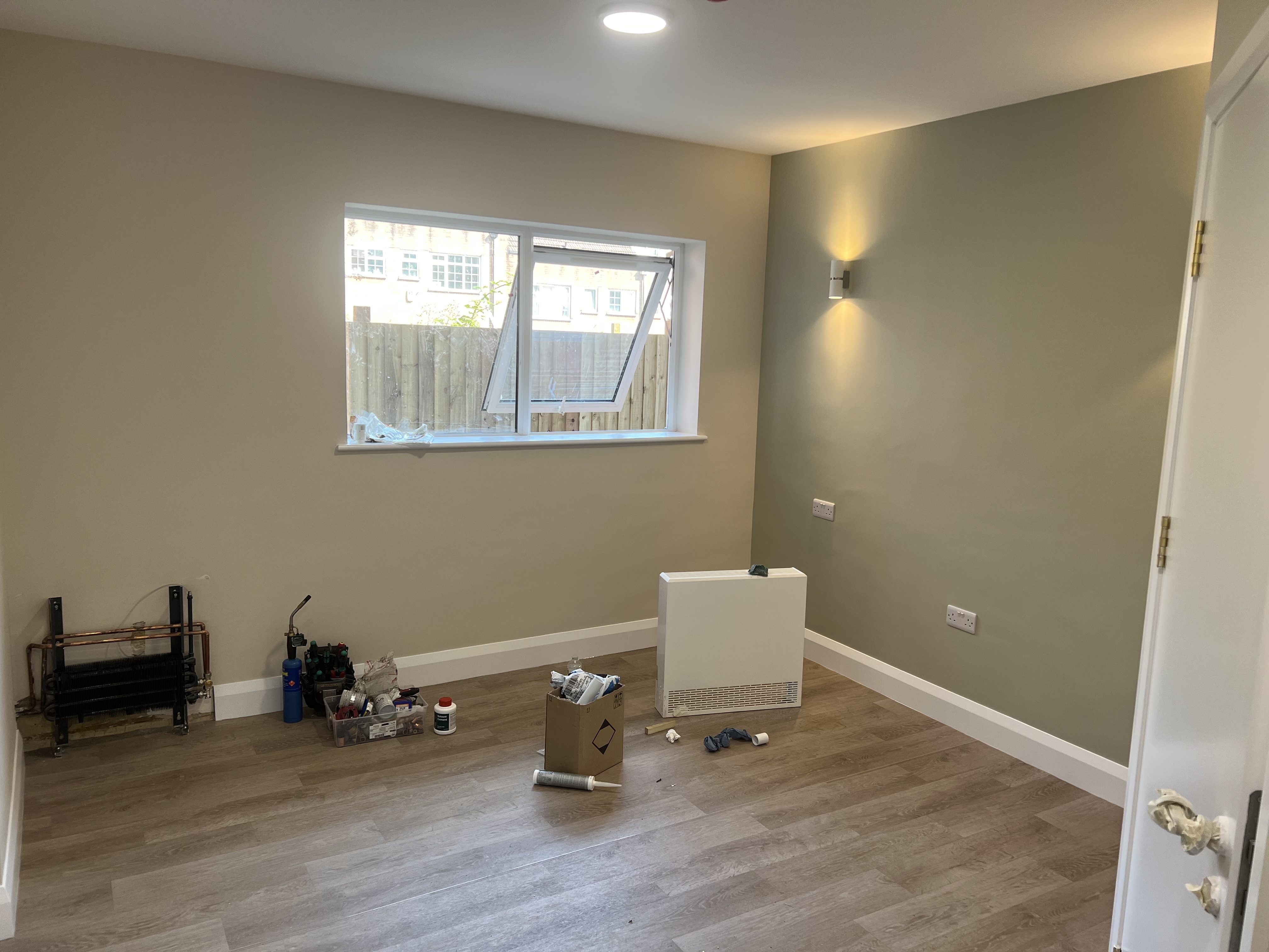 Room with olive green walls, white trim, and contemporary finish